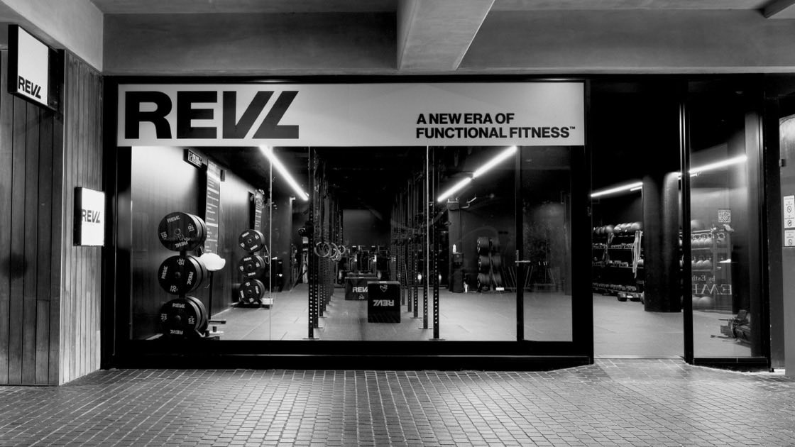 A REVL Training studio storefront at night